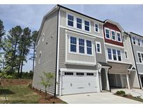 Charming three-story townhome with two car garage, neutral siding and an abundance of windows at 2201 Lambert Rd # 66, Cary, NC 27519