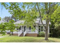 Charming home featuring a welcoming front porch and well-maintained landscaping at 2402 Cynthia Dr, Durham, NC 27704