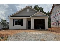 Charming single-story home featuring an attached garage and classic architectural details under construction at 245 Bluejay St, Clayton, NC 27520