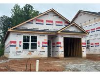 Front exterior of a home under construction with visible framing and HomeGuard branded weather-resistant barriers at 245 Bluejay St, Clayton, NC 27520