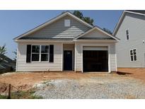 Charming single-story home featuring light siding, black shutters, and an attached garage, ready for new owners at 245 Bluejay St, Clayton, NC 27520