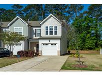 Charming townhome featuring a one car garage and a well maintained lawn at 261 White Oak Ridge Dr, Garner, NC 27529