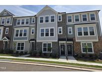 Attractive new townhome exterior with stone accents and manicured landscaping at 3020 Freewinds Way # 47, Cary, NC 27519