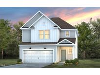 Charming two-story home with a two-car garage, green lawn and beautiful architectural details at 3231 Pelican Ln, Durham, NC 27703