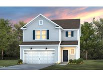 Charming two-story home featuring an attached two-car garage and manicured front lawn at 3233 Pelican Ln, Durham, NC 27703