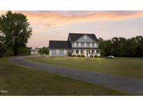 Charming two-story home with a spacious lawn and inviting front porch, perfect for relaxing evenings at 3805 Euliss Rd, Burlington, NC 27215