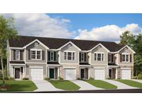 Charming townhomes featuring covered entry, single car garage, and a combination of stone and neutral siding at 400 Ember St, Sanford, NC 27330