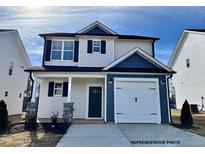 Charming two-story home with a one car garage, attractive curb appeal, and a well-manicured lawn at 49 Goldenrod Loop, Clayton, NC 27520