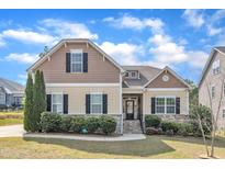 Charming two-story home with manicured lawn and stone accents, offering classic curb appeal at 615 Prides Crsg Xing, Rolesville, NC 27571