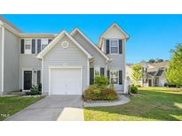 Charming townhouse featuring a one-car garage and well-maintained landscaping at 6539 Clarksdale Ln, Durham, NC 27713