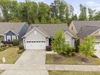 Charming single-story home with a manicured front yard, two-car garage, and lovely landscaping at 10 Currituck Ln, Durham, NC 27703