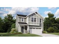 Charming two-story home featuring gray siding, a covered front porch, and an attached two-car garage at 120 Vulcan St, Garner, NC 27529