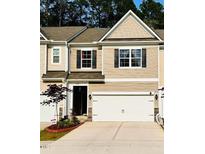Two-story home with neutral siding, a two-car garage, and a well-manicured front yard at 1240 Grenshaw Dr, Morrisville, NC 27560