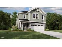 Charming two-story home features a classic design, a two-car garage and manicured lawn at 135 Vulcan St, Garner, NC 27529