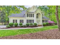 Charming white brick home featuring black shutters and lush landscaping, offering timeless curb appeal at 201 Johnstone Ct Ct, Durham, NC 27712