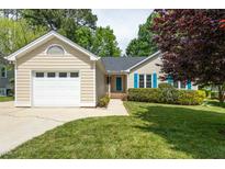 Charming single-story home featuring a one-car garage and vibrant blue shutters at 210 Needle Park Dr, Cary, NC 27513
