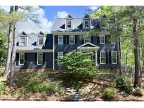 Charming two-story home with black shutters, dormer windows, and a beautifully landscaped front yard at 221 Ironwoods Dr, Chapel Hill, NC 27516