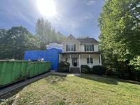 Charming two-story home with a welcoming front porch surrounded by lush greenery undergoing renovations at 249 Finley Ct, Clayton, NC 27520