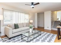 Bright living room with hardwood floors, a ceiling fan, modern furniture, and a large window for natural light at 3818 Hillgrand Dr, Durham, NC 27705