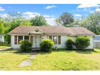 Quaint single-story home with a cozy front porch and mature landscaping, showcasing its classic charm at 414 N Cypress St, Wendell, NC 27591