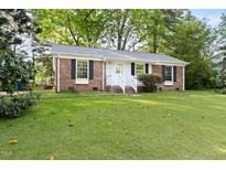 Charming single-story brick home with a well-maintained lawn and classic black shutters at 5802 Newhall Rd, Durham, NC 27713
