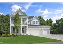 Beautiful two-story home featuring a brick facade, inviting porch, balcony, and well-manicured lawn at 8704 Maxine St # 1, Willow Springs, NC 27592