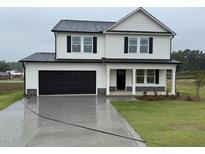 Two story home with black garage door and dark shutters at 10 Silver Ct, Smithfield, NC 27577