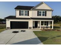 Charming two-story home with a black two-car garage and covered porch at 10 Silver Ct, Smithfield, NC 27577