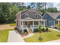 Charming two-story home with a welcoming front porch and well-manicured lawn at 1005 Forrestal Pl, Durham, NC 27707