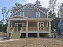 Charming two-story home with a covered front porch and wood railings at 1005 Forrestal Pl, Durham, NC 27707