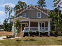 Charming two-story home with a welcoming front porch and neatly landscaped front yard at 1005 Forrestal Pl, Durham, NC 27707