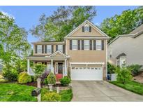 Charming two-story home featuring a classic design, a two-car garage, and a welcoming front porch at 101 Hay Sedge Ct, Durham, NC 27705