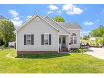 Charming single-story home with gray siding, black shutters, and a well-manicured lawn at 106 Northwinds Dr, Wendell, NC 27591