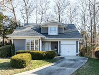 Charming one-story home features a manicured lawn, gray siding, and an attached one car garage at 11 Whitburn Pl, Durham, NC 27705