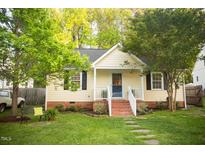 Charming single-story home featuring a well-manicured lawn and inviting front porch at 112 E Edgewood Dr, Durham, NC 27704