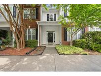 Charming townhome with brick accents, manicured landscaping, and a welcoming front entrance at 126 Star Thistle Ln, Cary, NC 27513