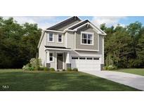 Charming two-story home with a two-car garage and landscaped front yard at 127 Vulcan St, Garner, NC 27529
