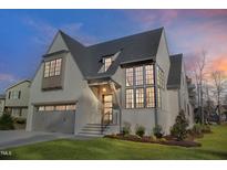 Stunning two-story home with brick facade, large windows, and well-manicured lawn at 1400 Hedgelawn, Raleigh, NC 27615