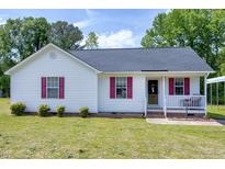 Charming single-story home featuring red shutters and a well-maintained front yard at 141 Montesino Dr, Raleigh, NC 27603