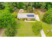 Charming home with solar panels, pool, and fenced yard surrounded by lush trees at 149 Baldwin Dr, Durham, NC 27712