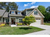 Charming single-Gathering home with a two-car garage and well-manicured landscaping, offering curb appeal and a welcoming entrance at 199 Telluride Trl, Garner, NC 27529