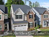 Beautiful two-story home featuring stone and siding, a two-car garage, and well-maintained landscaping at 2323 Big Sky Ln, Raleigh, NC 27615