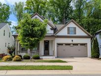 Charming one-story home with a two-car garage and a welcoming front porch at 2472 Patriot Bluffs Dr, Fuquay Varina, NC 27526