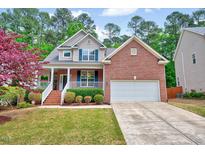 Charming brick two-story home with a covered front porch and well-manicured lawn at 2639 Oleander Dr, Durham, NC 27703