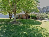 Charming single-story brick home with well-manicured front lawn and mature shade trees at 2715 Freemont Rd, Durham, NC 27705