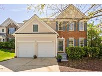 Charming two-story home with a brick facade, two-car garage, well-maintained lawn, and a cheerful, welcoming entrance at 3302 Colorcott St, Raleigh, NC 27614