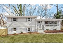 Charming home featuring new white paint, gray shutters, fresh landscaping, and a well-manicured front yard at 3408 Brentwood Rd, Raleigh, NC 27604