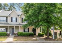 Charming townhome featuring a covered porch and well-maintained landscaping at 4000 Volkswalk Pl, Raleigh, NC 27610