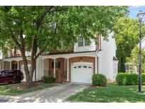 Charming two-story townhouse with a one car garage, brick accents, and beautiful landscaping at 4540 Mistiflower Dr, Raleigh, NC 27606