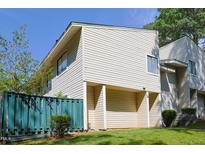 Inviting two-story exterior with a teal fence and covered parking at 4602 Millstone Dr # C, Raleigh, NC 27604